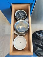 Drawer view showing stack of six mixed pet bowls