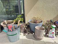 Overall lot showing bucket with tools, assorted pots, saucers and spray bottle