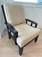 Front angled view of chair showing frame finish and cushions