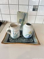 All four pottery pieces grouped on counter