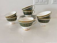 Group view of stacked teacups and saucers showing pattern and overall quantity