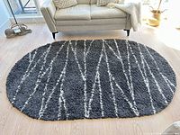 Top view of full oval rug placed under sofa