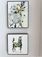 Both framed prints mounted vertically on wall