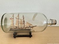Full view port side of bottle with ship model on stand