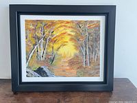 Front view of framed autumn forest oil painting