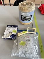 Group shot of all four items: sisal twine spool, shelf pegs bag, tealight candle box, magnifier