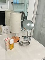 Group shot of lamp, mirror, soap dish and cologne