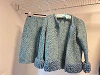 Full view of jacket and skirt hanging