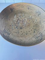 Top view of the brass bowl showing full dragon and floral inlay design