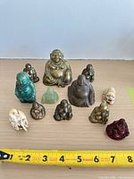 Group shot of all figurines with ruler for scale