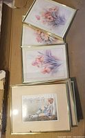 Overhead view of several frames with child and floral art