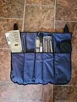 Full view of blue carry case with BBQ tools inside pockets