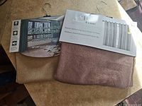 Both packaged curtain panels showing labels and colours