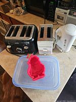 Group shot: both toasters, kettle, silicone mold, plastic container