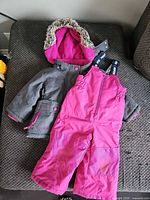 Full snowsuit laid out showing both jacket and bibs