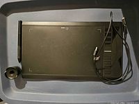 Tablet front view with stylus, pen holder, and USB cable