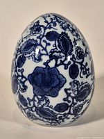 Front view of cobalt blue and white porcelain egg with floral pattern