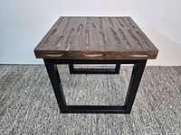 Full view of square side table showing wood top and metal frame