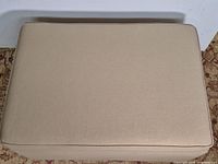 Top view of beige upholstered ottoman lid