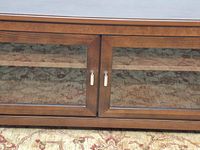 Front view showing two glass doors, wood frame, metal pulls