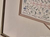 Lower left corner showing calligraphy border, floral motifs, and frame detail