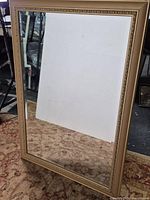 Full view of rectangular gold framed mirror