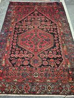 Full view of the handmade Persian rug showing overall design and colors