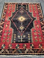 Full view of rug showing overall pattern, colors, fringe