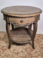 Front three-quarter view of table showing drawer, legs, shelf