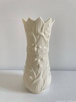 Front view of Belleek Lily of the Valley vase showing floral relief and scalloped rim