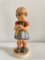 Front view of Goebel Hummel A Stitch in Time #255 figurine