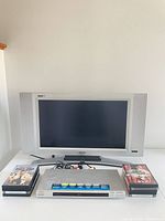 Front view of Magnavox TV, Sony DVD player, DVD stacks