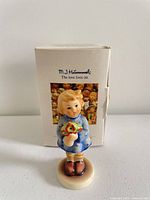 Front view of figurine with box