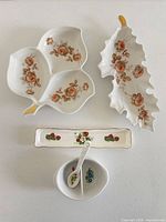 All five pieces laid out: clover dish, leaf tray, pen rest, condiment bowl and spoon
