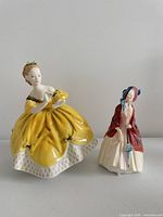 Both Royal Doulton figurines side by side for scale and comparison