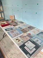 Wide view of table showing entire assortment of books, binders, leaflet packs and Jiffy kit