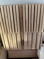 Stacked bamboo cutting boards showing grooved faces