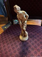 Full front view of resin female figurine on chair