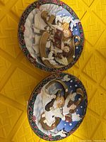 Front view of both angel musical plaques showing relief detail and colours
