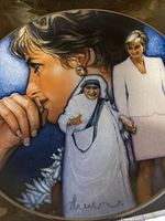 Full view of the commemorative plate showing printed portraits of Princess Diana and Mother Teresa