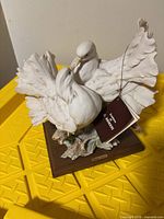 Full view of porcelain dove pair on wood base