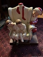 Front view showing Santa, chair and two children