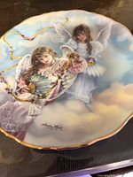 Front of plate showing angel design and gold rim