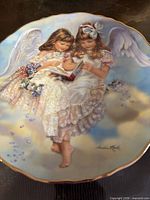 front view of plate showing full angel scene and gold rim