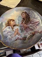 Front view of plate showing angel artwork and gold rim