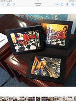 three framed prints grouped on table, shows overall set