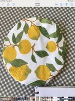 Top view of lemon-print fabric bowl cover laid flat