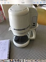 Front view of white KitchenAid coffee maker with carafe
