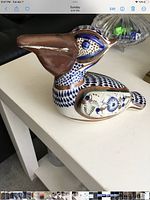 Left side view of ceramic pelican showing colour pattern and glaze