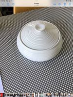 White ridged casserole dish with lid on checkered surface